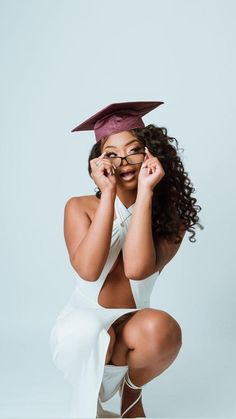 a woman wearing glasses and a graduation cap