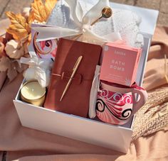 a gift box with candles, soaps and other items in it on a table