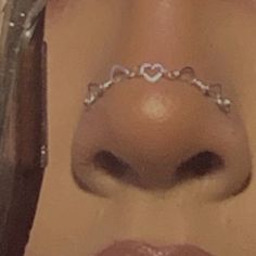 a close up of a nose with a chain around it's mouth and a heart on the lip