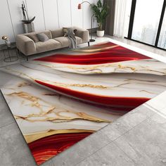 a living room area rug with red, white and gold designs on the floor in front of a couch