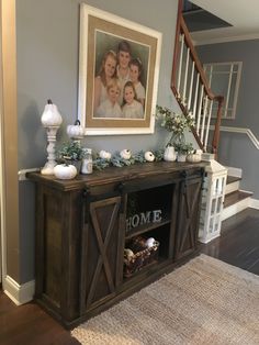 a family portrait hangs on the wall next to an entertainment center