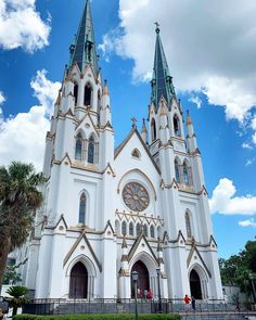 a large white church with two towers and a clock on it's front side