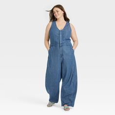 Embrace casual chic with this Curved-Leg Denim Jumpsuit from Universal Thread™. The blue denim medium-wash jumpsuit is made of a midweight cotton-lyocell blend for comfortable all-day wear. The sleeveless design is given a sophisticated twist with the front snap placket over a half-length zipper fastening, while the flattering V-neckline and curved-leg silhouette offer a breezy look. Multiple front and back pockets complete the design with functional flair. Universal Thread™: Found exclusively a Denim Jumpsuit Sleeveless, Jean Jumpsuit Outfit, Short Sleeve Denim Jumpsuit, Denim Jumpsuit Outfit, Womens Denim Jumpsuit, Womens Denim Overalls, Baggy Jumpsuit, Maxi Jumpsuit, Jumpsuit Outfit