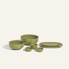 green bowls and plates on a white background