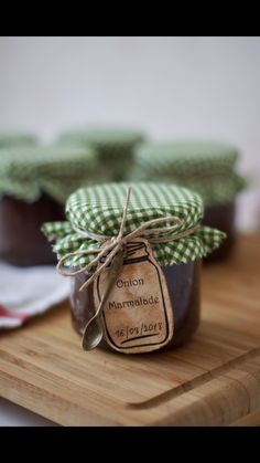 a jar of jam sitting on top of a wooden cutting board