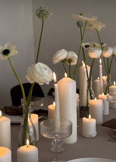 there are many white candles on the table