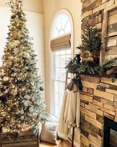 This rustic living room features a pine tree and garland on the dark wood mantel of a stone fireplace. A tree with gold Christmas tree decorations stands in front of an off-white wall with tall white shiplap wainscoting. A rustic wood box is placed on the warm wood floor...   Image: ourrustichaven Shiplap Wainscoting, Warm Wood Flooring, Rustic Wood Box, Gold Christmas Tree Decorations, Wood Mantel, Off White Walls, Gold Christmas Ornaments, Wood Mantels, White Shiplap