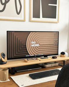 a computer monitor sitting on top of a wooden desk