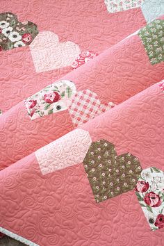 pink quilt with hearts and flowers on it