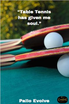 two ping pong paddles sitting next to each other on top of a table