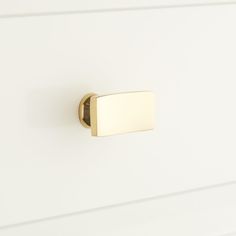 a close up of a door handle on a white cabinet