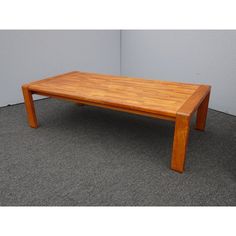 a wooden table sitting on top of a carpeted floor