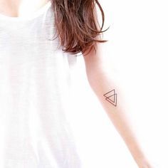 a woman with a small triangle tattoo on her arm