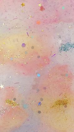 an abstract painting with gold, pink and blue paint splattered on the ground