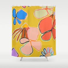 a yellow shower curtain with colorful flowers and butterflies on the outside, against a white background