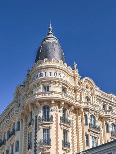 an ornate building with the word carlton written on it's side and balconies at the top