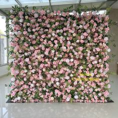 an artificial flower wall in the middle of a room