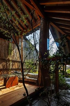 the inside of a wooden structure with trees and benches on it's deck area