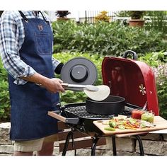 a man cooking food on top of a grill