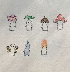 a group of small cartoon figures on a white surface with flowers and mushrooms in the background