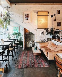 a living room filled with furniture and lots of plants