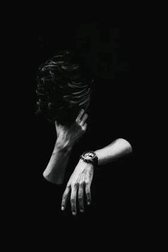 black and white photograph of a woman's hand on her face in the dark