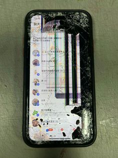 a broken cell phone sitting on top of a table