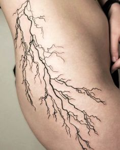 a woman's thigh with lightning bolt tattoo on it