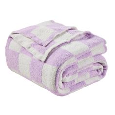 the purple and white striped towel is folded on top of it's own blanket