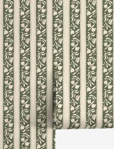 a green and white striped wallpaper with flowers on it