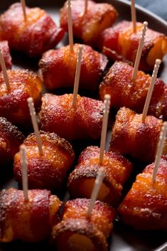 bacon wrapped in toothpicks with toothpicks sticking out of them to eat