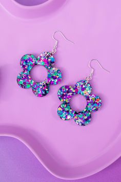 A pair of handmade glittery resin earrings, designed to make you look & feel extra. Playful, eye-catching and vibrant, perfect for festivals, parties, special occasions or just to add a touch of sparkle to your everyday look.  Each pair is meticulously crafted with love and attention to detail, ensuring that you receive a unique piece of jewellery that will make you shine.  A combination of high-quality resin and carefully selected glitter creates a mesmerising effect that catches the light and Glittery Earrings, Resin Earring, Festival Earrings, Bright Winter, Daisy Earrings, Earrings Cute, Resin Earrings, Earrings Statement, Cute Earrings