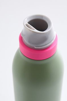 a green water bottle with a white lid and pink trim on the top, sitting against a white background