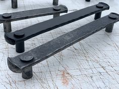 two black benches sitting on top of a white floor