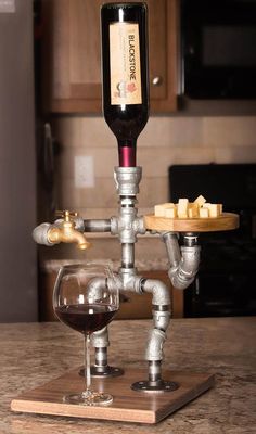 a wine glass sitting on top of a wooden table next to a corkscrew