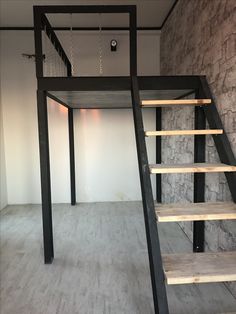 an empty room with stairs leading up to the second floor and a light fixture hanging from the ceiling