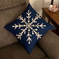 a blue pillow sitting on top of a brown couch