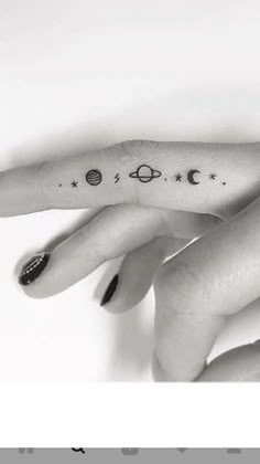 a woman's hand with tattoos on it and the word saturn written in black ink