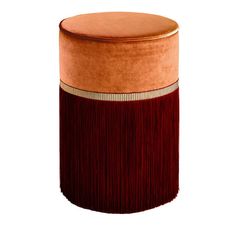 an orange and brown stool with fringe on the top, sitting in front of a white background