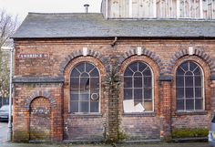 an old brick building with arched windows