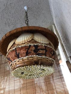 a basket hanging from the ceiling with shells on it