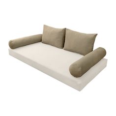 a white couch with two pillows on it and a pillow in the shape of a reclining