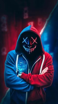 a person wearing a red and blue hoodie with a skull on the face holding a cell phone