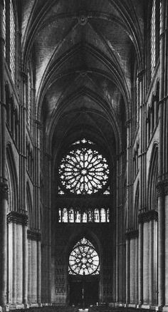 an old photo of the inside of a church with stained glass windows and pews