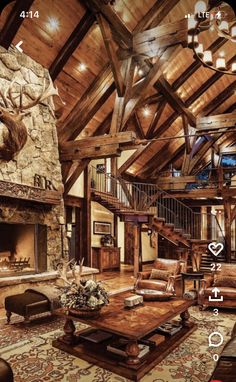 a living room filled with furniture and a fire place in the middle of a wooden ceiling