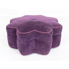 a purple ottoman with pink piping on top