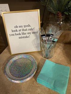 a table topped with a glass vase filled with water and a plate covered in confetti