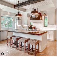 a kitchen with an island and stools in it