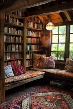 a room filled with lots of books on top of a wooden shelf next to a window