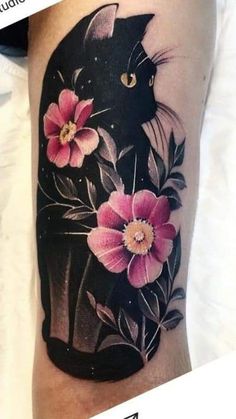 a black cat with pink flowers on it's leg